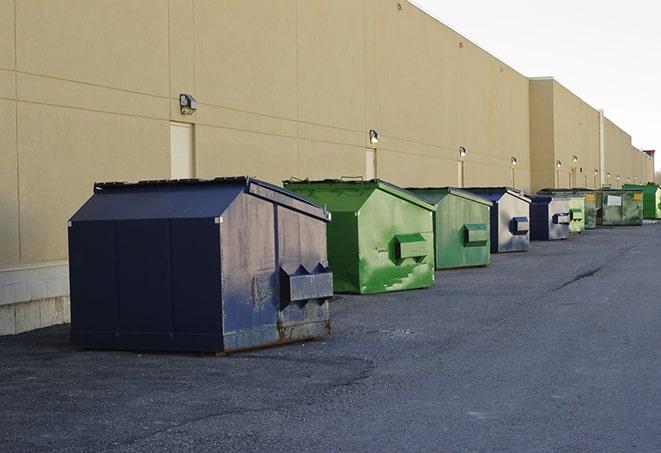 an assortment of sturdy and reliable waste containers near a construction area in Bourbon